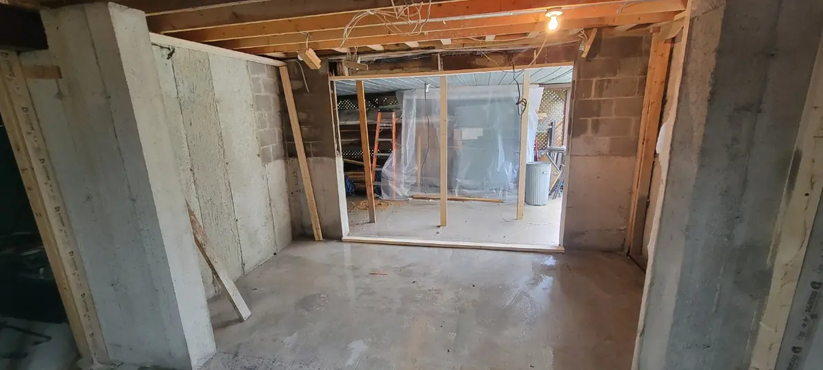 Nouvelle ouverture dans le mur de blocs vue du sous-sol, plancher nettoyé