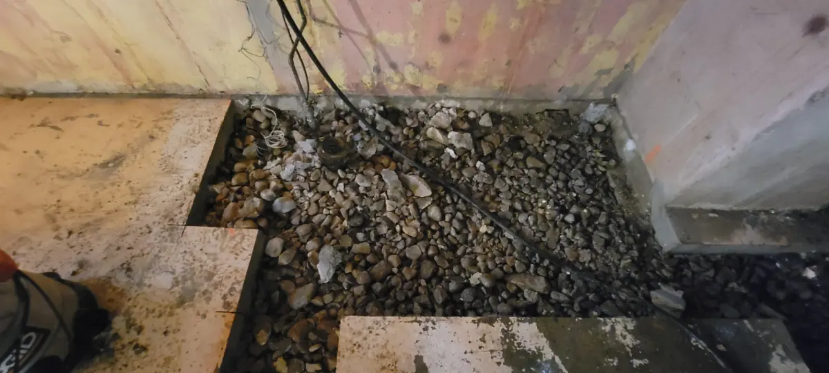 Tranchée de plomberie remplie de gravier avant la coulée