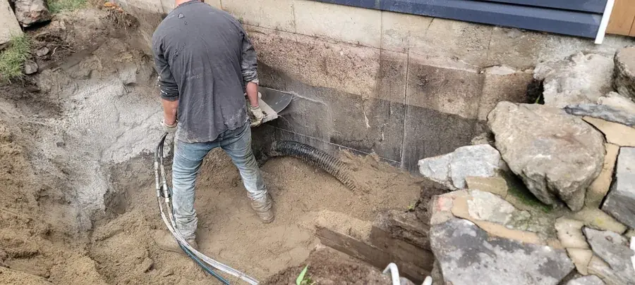Opérateur et boyaux de la scie hydraulique dans l'excavation